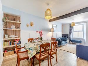 a dining room with a table and chairs at Primrose Cottage in Teignmouth