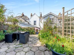 a garden with a table and a fence at Primrose Cottage in Teignmouth