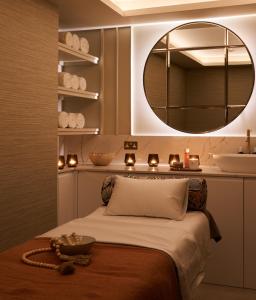 a bedroom with a bed with a mirror and candles at The Nici in Bournemouth