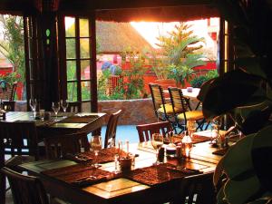a restaurant with wooden tables and chairs with glasses on them at Desert Springs Resort in Vera +40 photos