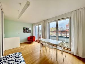 a room with a table and chairs and a large window at Elegant Apart-800m Main Square-Parking and lift in Wrocław