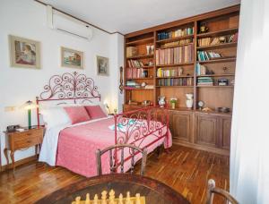 a bedroom with a bed and a book shelf at Villa Tanca With AC, Terrace and Views in Monterosso al Mare