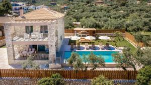 an aerial view of a house with a swimming pool at Claudio Stone House in Vasilikos