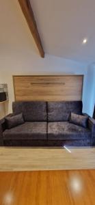 a brown couch in a room with a wooden floor at Vieux Nice a 2min de la mer in Nice