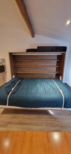 a large bed in a bedroom with a wooden headboard at Vieux Nice a 2min de la mer in Nice