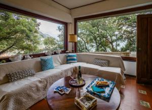 a living room with a couch and a table at Villa Tanca With AC, Terrace and Views in Monterosso al Mare
