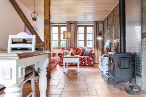 a living room with a fireplace and a stove at Kamin-Haus-Nr-2-mit-Sauna-in-Burg in Fehmarn