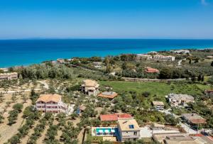 an aerial view of a house and the ocean at Claudio Stone House in Vasilikos