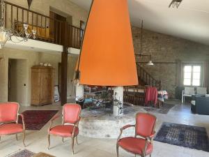 a living room with chairs and a fireplace at Villa de 5 chambres avec piscine privee jardin amenage et wifi a Saint Maime in Saint-Maime