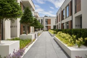 a walkway in front of a building at Olimpijska by RENT4YOU in Olsztyn +111 photos