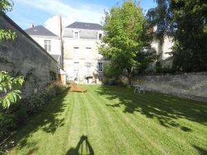 a shadow of a person standing in a yard at A la Fleur de Lys in Langeais