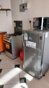 a kitchen with a refrigerator and a stove at One Bedroom Beach Apartment/Pool/Free Wi-Fi in Mombasa +16 photos