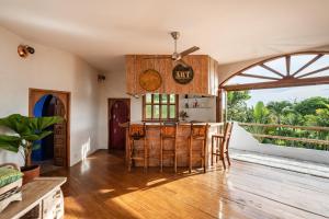 a kitchen with wooden floors and a table and chairs at Casa Mila - 4BR Luxury Villa 5 Min from Canggu Beach in Canggu