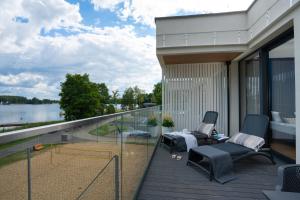 a balcony of a house with a view of the water at Olimpijska Premium by RENT4YOU in Olsztyn