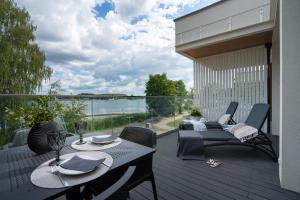 a patio with a table and chairs on a deck at Olimpijska Premium by RENT4YOU in Olsztyn