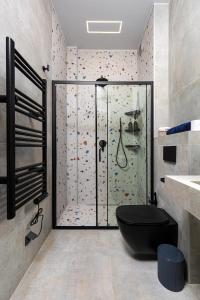 a bathroom with a shower with a black toilet at Industrial-style 2BD Loft with Parking Spot in Plovdiv