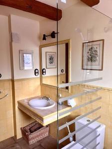 a bathroom with a sink and a mirror at Apartment in country house with views and pool in Vespellá