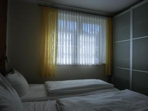 a bedroom with a bed in front of a window at Ferienwohnung KK26 in Graal-Müritz