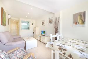a white room with a bed and a living room at Coblanca 3-105 in Benidorm