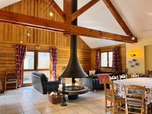 a living room with a fireplace in a house at Le Catelan in La Paute