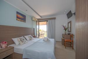 a hotel room with a bed and a balcony at Zefiros by sea in Laganas