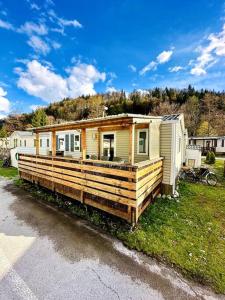 a tiny house sitting on the side of the road at Bungalow 3 chambres pour 6 pers avec Climatisation Camping 3 etoiles in Samoëns