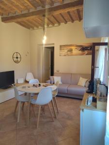 a living room with a table and a couch at Serendipity House in Grosseto