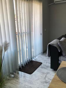 a living room with white blinds on a window at Centre apartment in Prilep