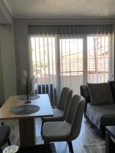 a living room with a table and chairs and a couch at Centre apartment in Prilep