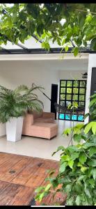 a living room with a couch and some plants at La Morenita in Puerto Triunfo