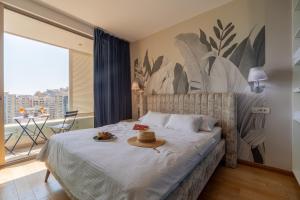 a bedroom with a bed with a hat on it at City Apartments 2 in Budva