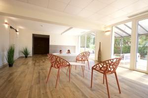 a dining room with a table and two chairs at Village Club Miléade Les Issambres -Val d'Esquières in Les Issambres