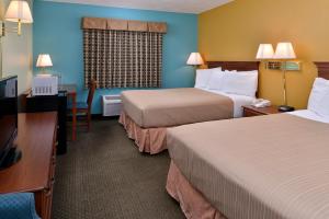 a hotel room with two beds and two lamps at Americas Best Value Inn - Seymour in Seymour