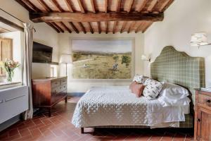 a bedroom with a bed and a large window at Borgo Vescine in Radda in Chianti