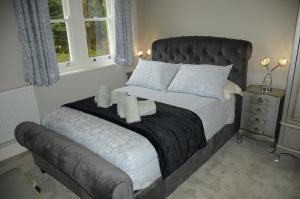 a bedroom with a large bed with towels on it at A Delightful Historic Torbay Hidden Gem! in Stokeinteignhead