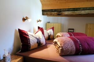 a bedroom with two beds with pillows on it at Chasa Prümaran in Scuol