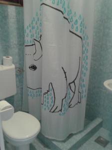 a bathroom with a shower curtain with a bear on it at Apartments D & P in Korčula