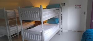 two white bunk beds in a small room at The Benwiskin Centre in Ballaghnatrillick
