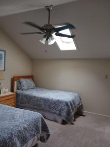 a bedroom with two beds and a ceiling fan at Regatta Bay in Lake Ozark