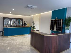 a lobby with a blue counter and a bar at Hotel il Rosone in Trecase