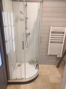 y baño con ducha y puerta de cristal. en Gite du moulin, en La Mothe-Saint-Héray