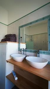 a bathroom with two white sinks and a mirror at Maison familiale niçoise avec terrasse in Nice