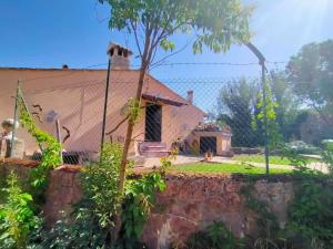 a house with a fence in front of it at Il Cerqueto in Spoleto