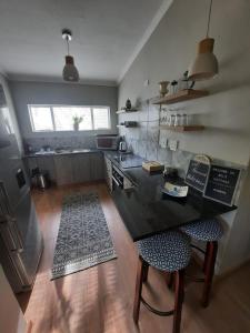 a kitchen with a table and two chairs in it at Nel's Cottage, a private and peaceful cottage in Benoni