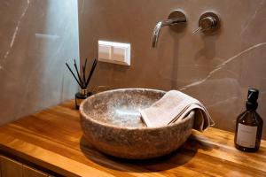 a bathroom with a large bowl sink on a wooden counter at Pyramidenkogel Lodge in Keutschach am See