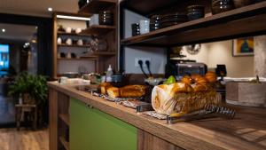 a counter with a bunch of loaves of bread on it at Hôtel Vauban in Le Palais