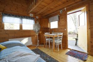 a bedroom with a bed and a table in a cabin at Cozy cottage with 10 beds near Landvetter in Landvetter