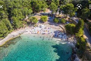 an aerial view of a beach with people in the water at Leda in Pula