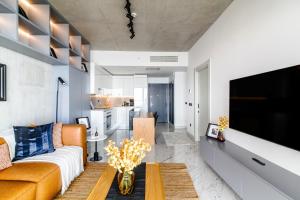 a living room with a couch and a tv at Chic and Scenic Studio Flat in Sisli in Istanbul
