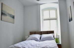 Łóżko lub łóżka w pokoju w obiekcie Narutowicza 5 Apartments